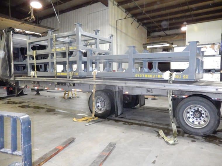 A truck is parked in the middle of a warehouse.