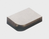 A rectangular piece of metal with a small amount of material on it.